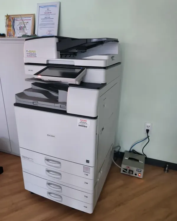 M&aacute;y photocopy Ricoh cho thu&ecirc; trong văn ph&ograve;ng s&agrave;n gỗ, cạnh bộ ổn &aacute;p